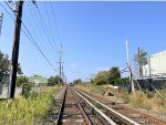 Looking east from the Long Beach Blvd Grade Crossing toward Long Beach. LIRR Train # 6816 is seen heading away in the distance.